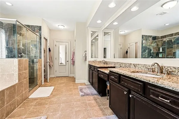 a large kitchen with a large counter top and sink