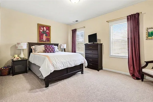 a bedroom with a bed and a television