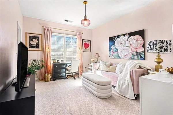 a living room with patio furniture and a flat screen tv