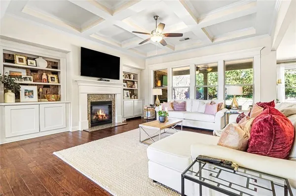 a living room with fireplace furniture and a flat screen tv