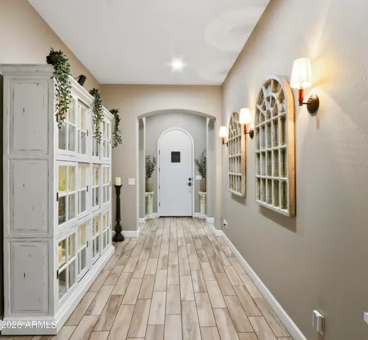 a view of a hallway with wooden floor and staircase