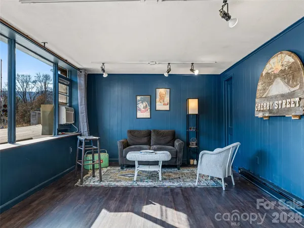 a view of a hallway view with wooden floor and staircase