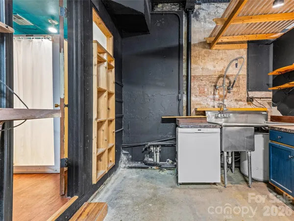 an aerial view of residential house and sandy dunes