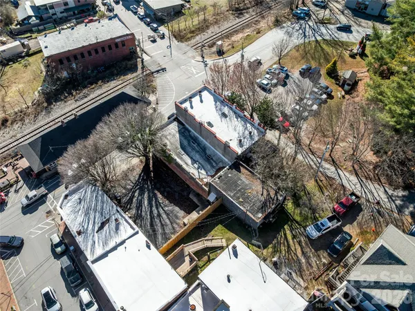 an aerial view of a house with a yard