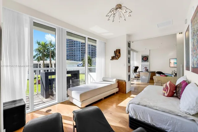a bedroom with a bed and a potted plant