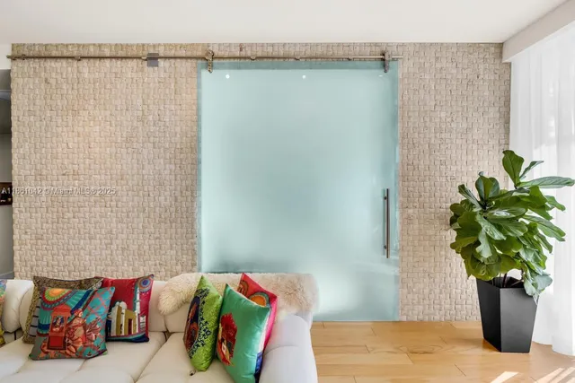 a bedroom with two beds and a potted plant