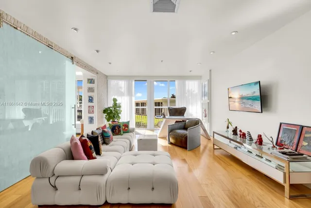 a living room with furniture and a wooden floor