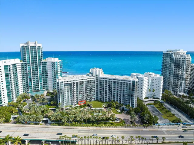 a living room with furniture a lamp and a large window
