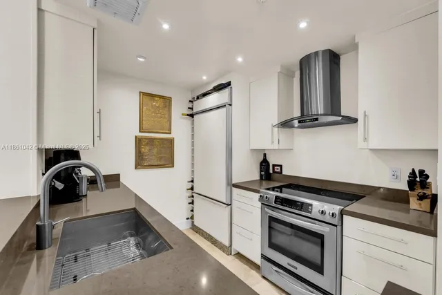 a kitchen with stainless steel appliances a sink and cabinets