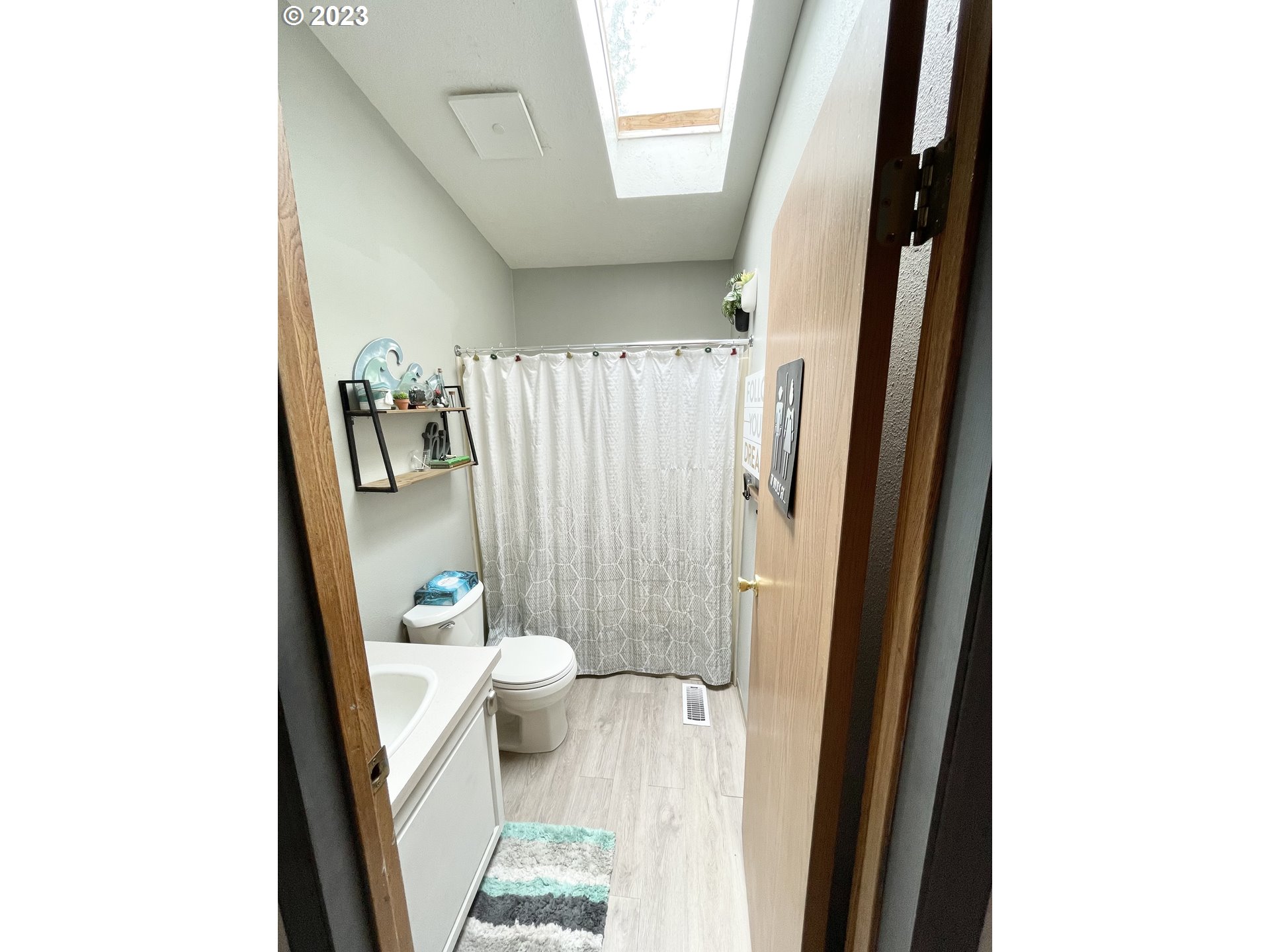 16625 South Redland Road Oregon City, OR 97045 - Photo 16 of 28 a bathroom with a sink a toilet and shower curtain