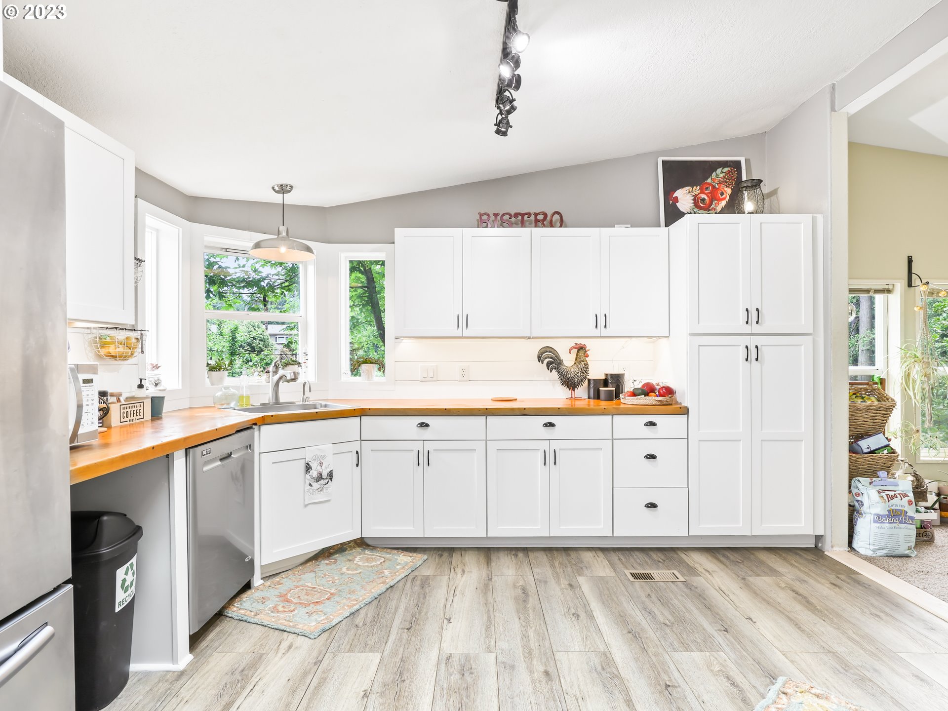 16625 South Redland Road Oregon City, OR 97045 - Photo 9 of 28 a kitchen with granite countertop white cabinets and white appliances