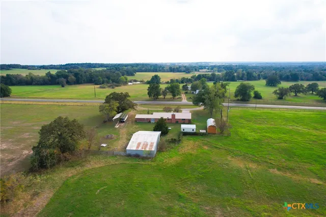 a view of a green field with sitting area