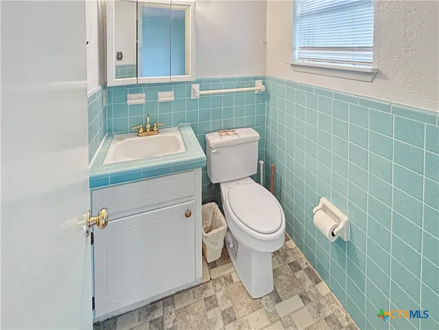 a bathroom with a toilet and a sink