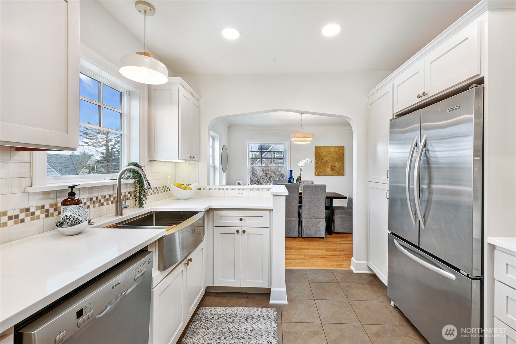 8401 Linden Avenue North Seattle, WA 98103 - Photo 11 of 36 a kitchen with a sink stainless steel appliances and cabinets
