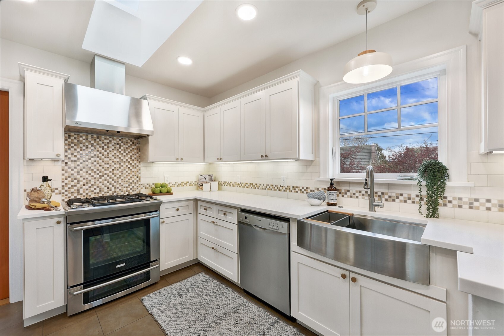 8401 Linden Avenue North Seattle, WA 98103 - Photo 13 of 36 a kitchen with a stove sink and cabinets