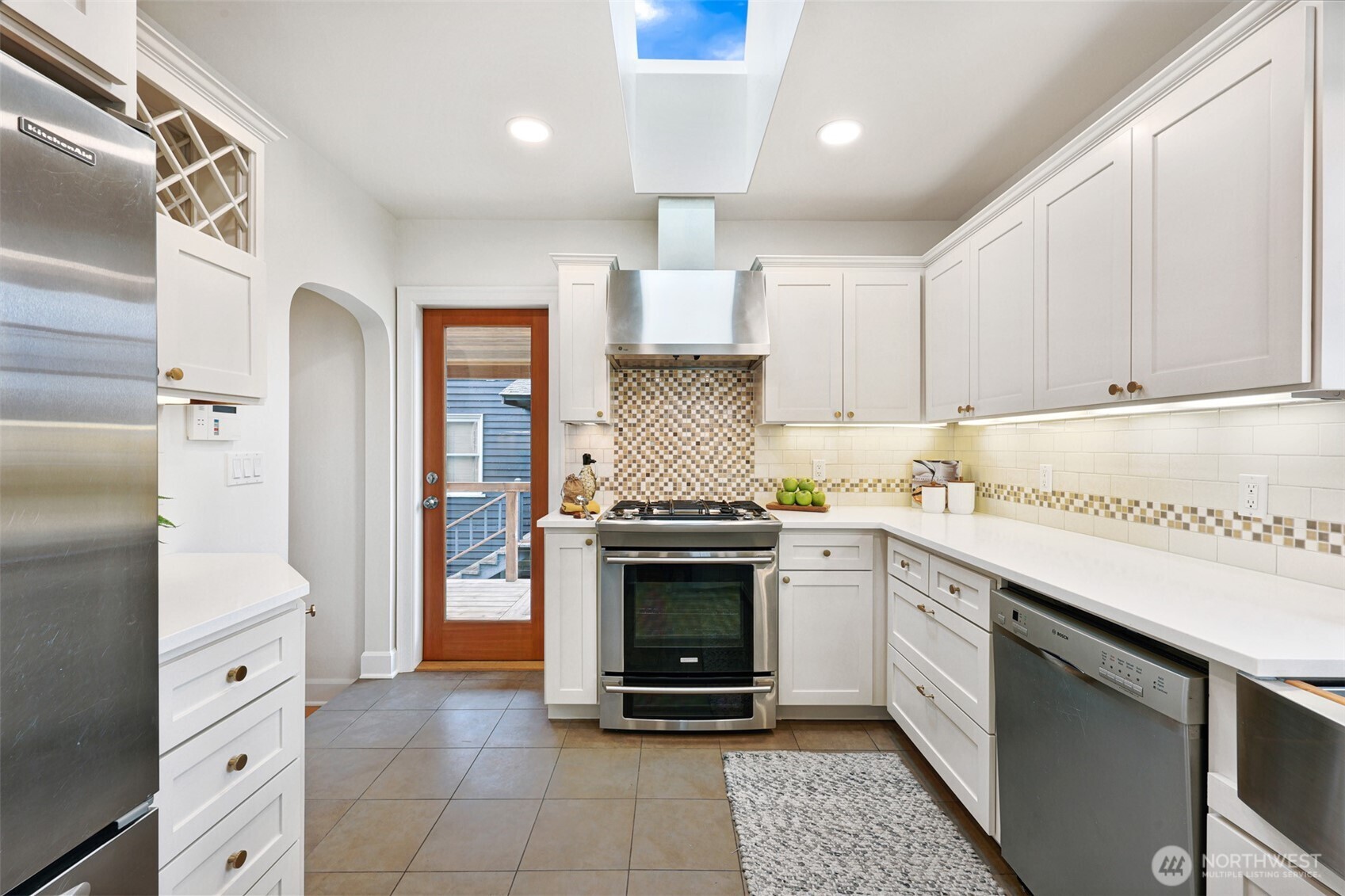 8401 Linden Avenue North Seattle, WA 98103 - Photo 14 of 36 a kitchen with stainless steel appliances granite countertop a stove and a refrigerator