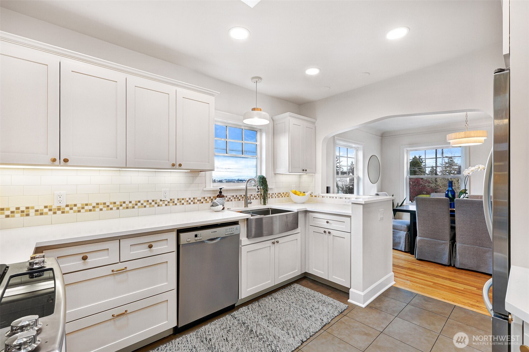 8401 Linden Avenue North Seattle, WA 98103 - Photo 15 of 36 a kitchen with a sink window and cabinets