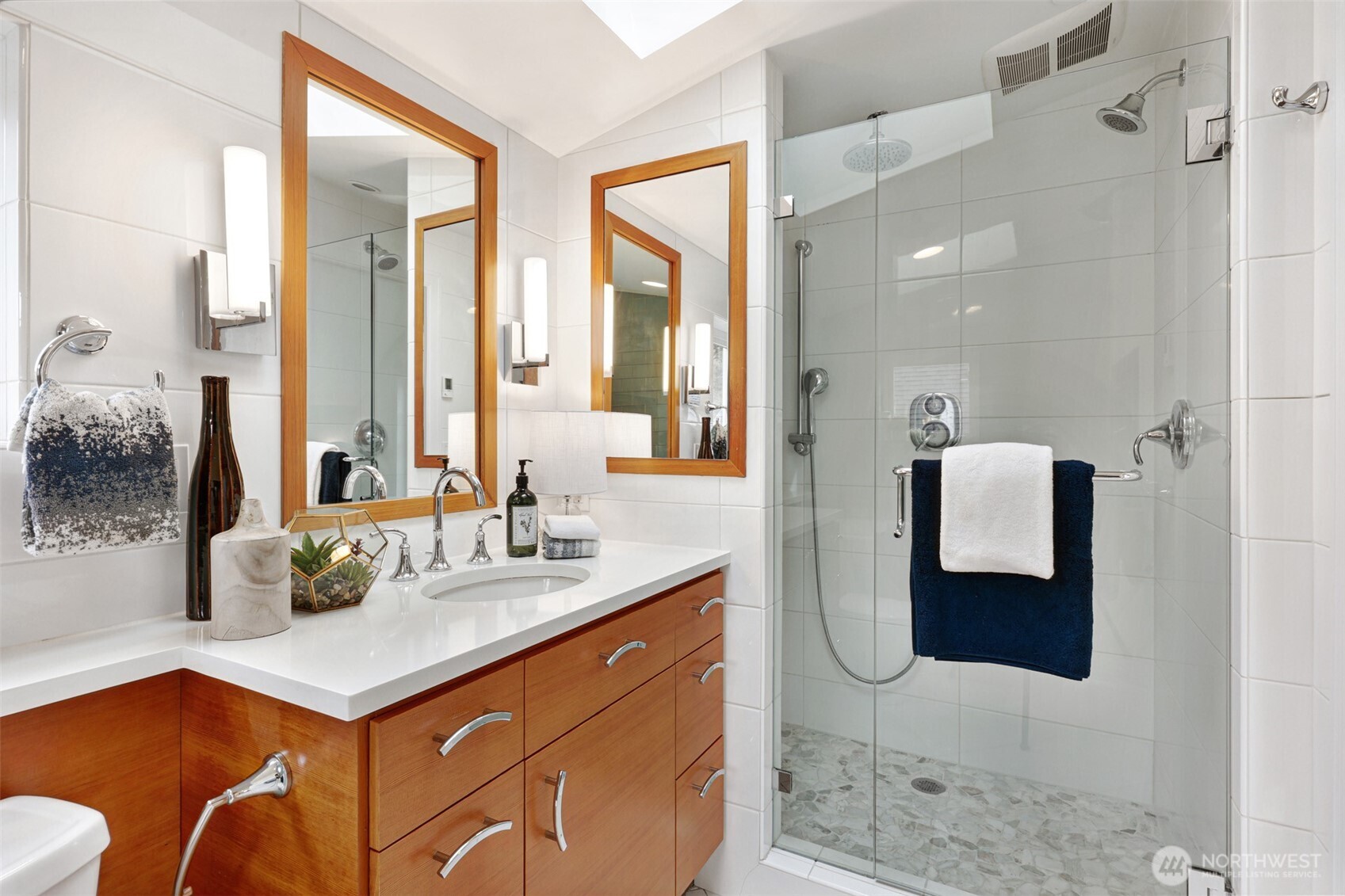8401 Linden Avenue North Seattle, WA 98103 - Photo 23 of 36 a bathroom with a tub sink and mirror