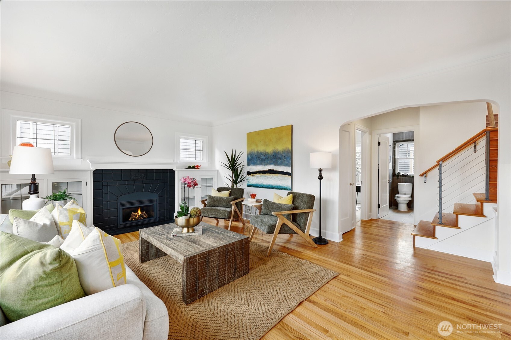 8401 Linden Avenue North Seattle, WA 98103 - Photo 6 of 36 a living room with furniture wooden floor and a fireplace