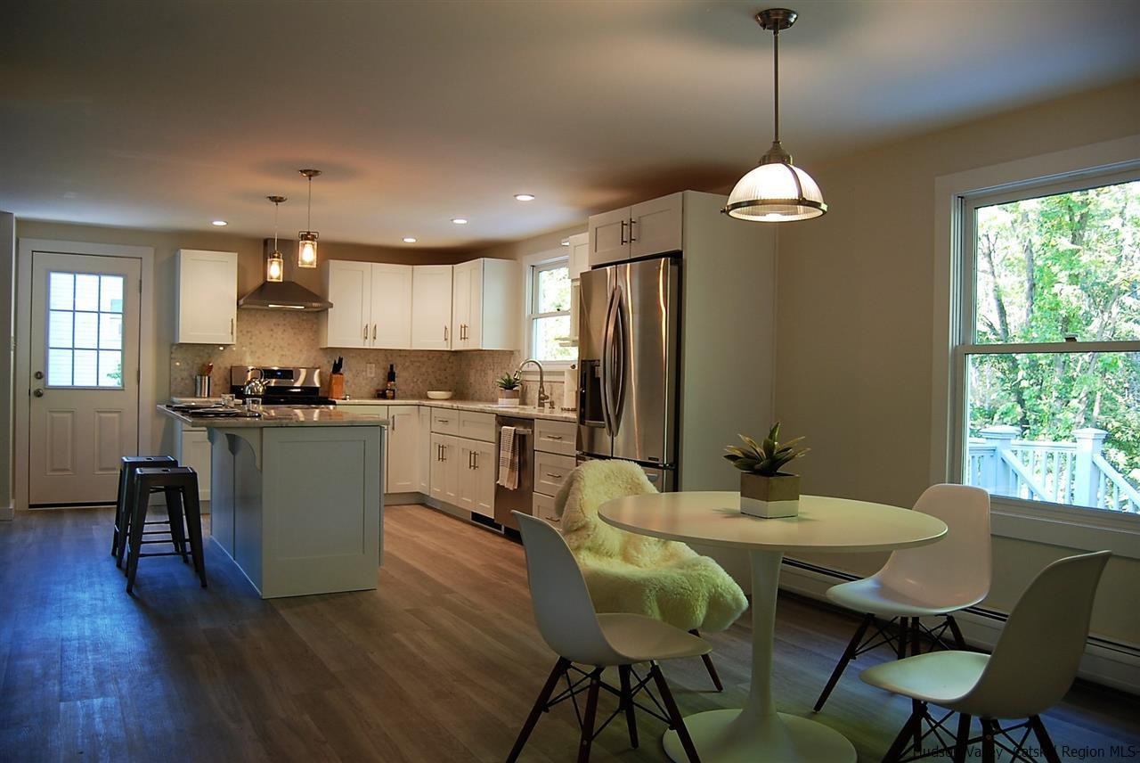 64 Mossybrook Road High Falls, NY 12440 - Photo 2 of 19 a kitchen with a dining table chairs refrigerator and sink