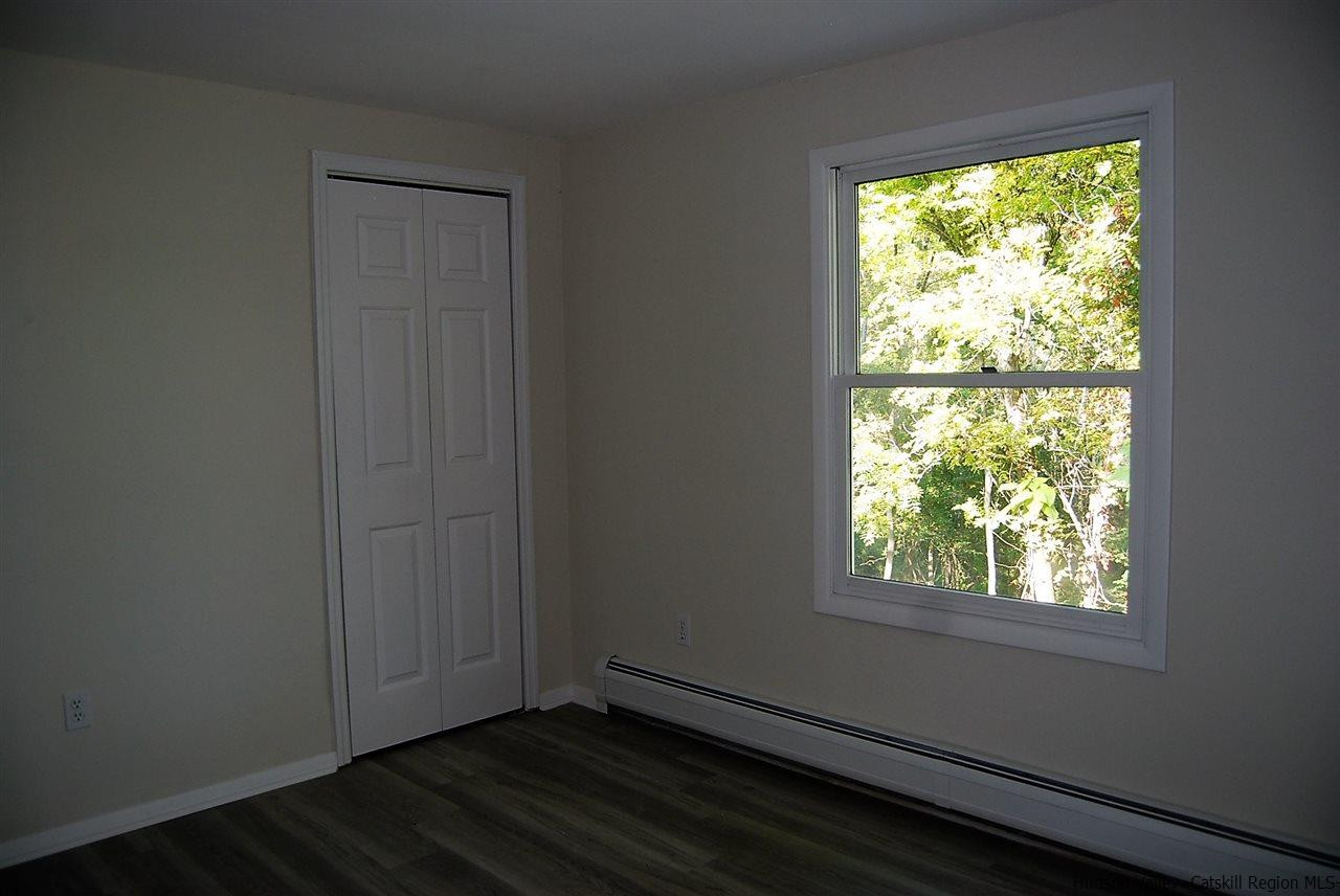 64 Mossybrook Road High Falls, NY 12440 - Photo 9 of 19 a view of an empty room with wooden floor and a window