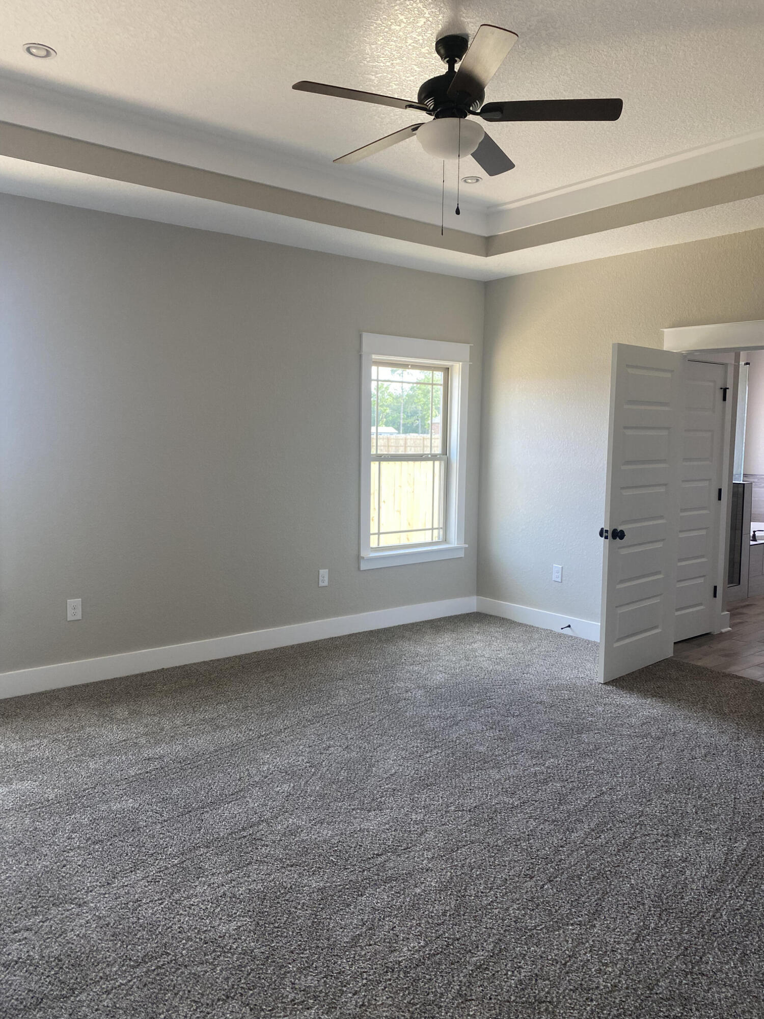 4085 Happy Trails Road Crestview, FL 32539 - Photo 9 of 19 an empty room with windows and fan
