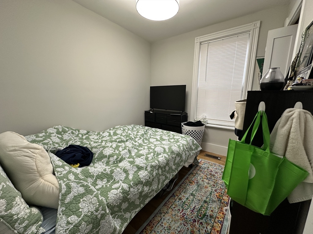 68 L Street, Unit 1 Boston, MA 02127 - Photo 11 of 12 a bedroom with a bed and a television