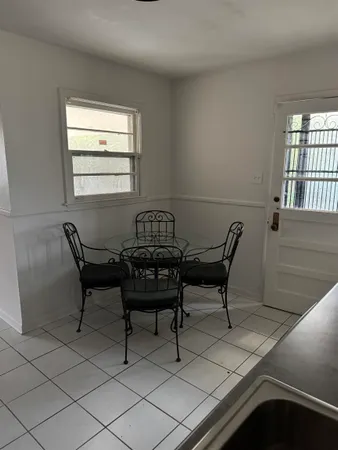 a view of a workspace with furniture and window