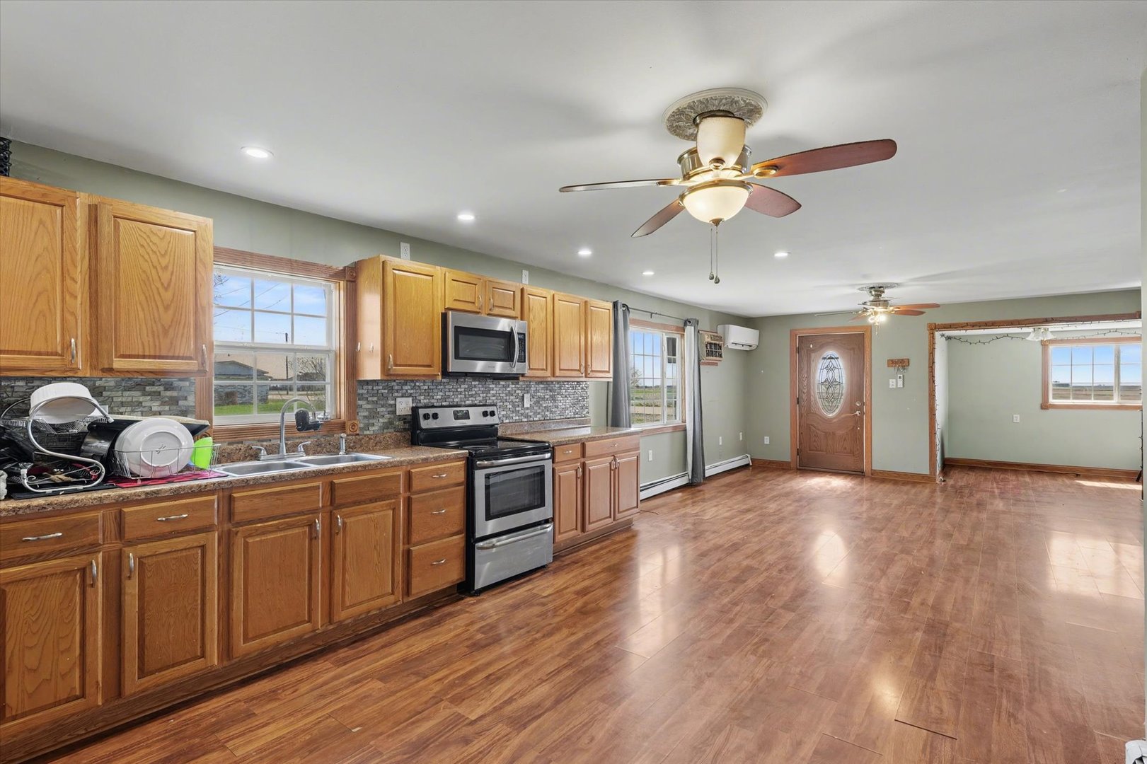 110 Highway 54 Roberts, IL 60962 - Photo 11 of 31 a kitchen with stainless steel appliances granite countertop a sink cabinets and wooden floor