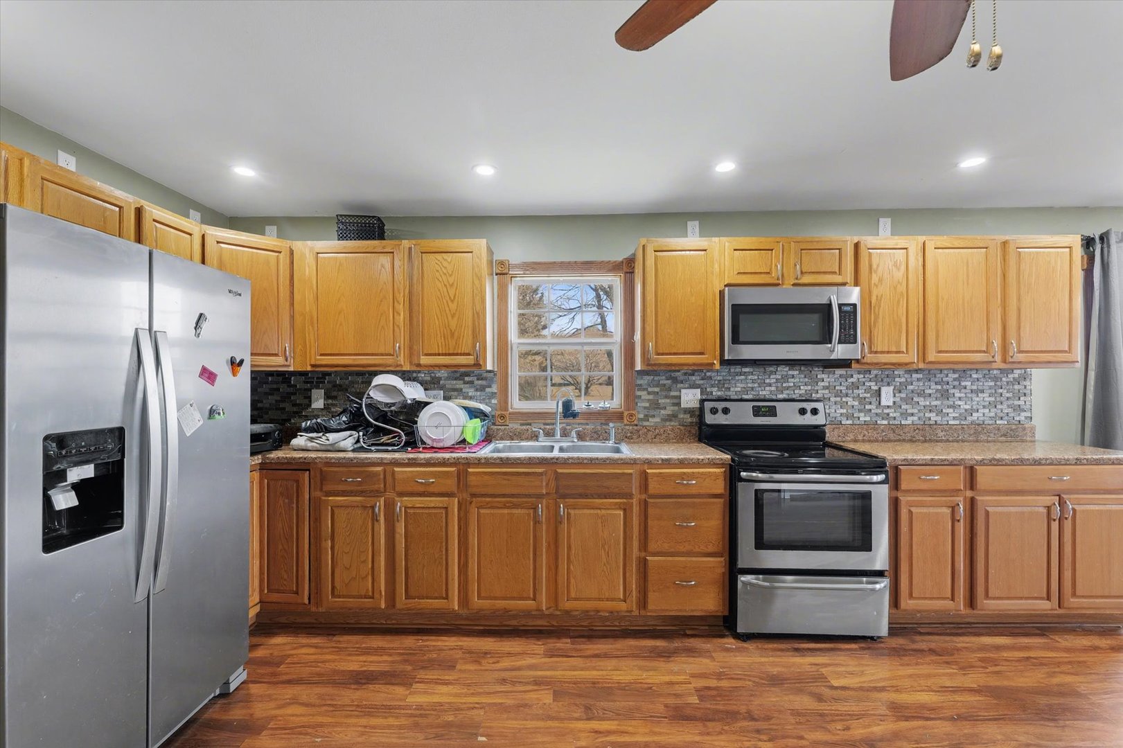 110 Highway 54 Roberts, IL 60962 - Photo 12 of 31 a kitchen with stainless steel appliances granite countertop a stove a sink and a refrigerator