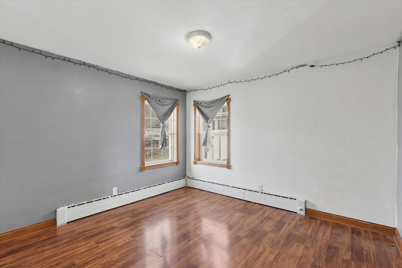 110 Highway 54 Roberts, IL 60962 - Photo 14 of 31 a view of an empty room with a window and wooden floor
