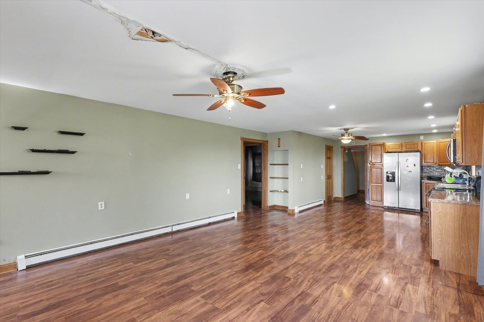 110 Highway 54 Roberts, IL 60962 - Photo 6 of 31 an empty room with wooden floor and a ceiling fan