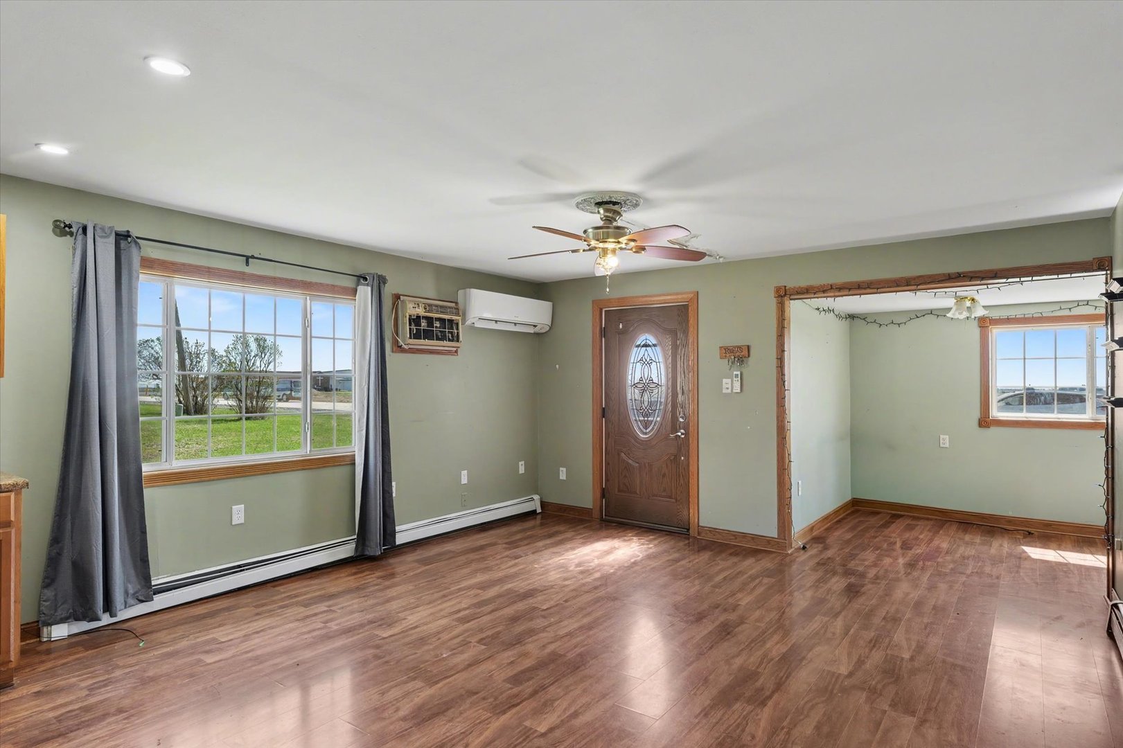 110 Highway 54 Roberts, IL 60962 - Photo 8 of 31 an empty room with chandelier fan and windows