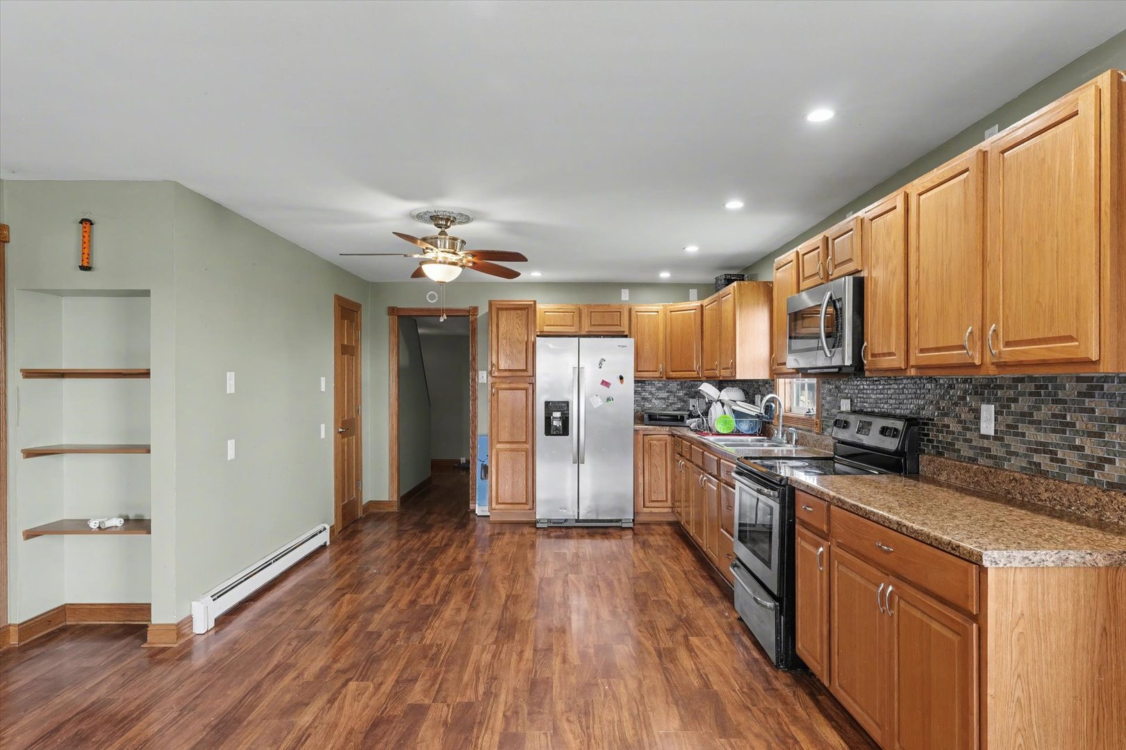 110 Highway 54 Roberts, IL 60962 - Photo 10 of 31 a kitchen with stainless steel appliances granite countertop hardwood floor sink stove and wooden cabinets