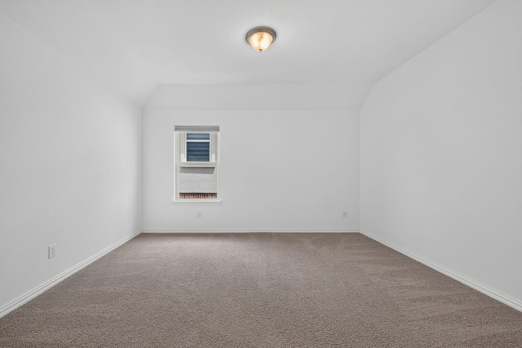 1332 Ridge Runner Drive Georgetown, TX 78628 - Photo 31 of 40 An inviting secondary bedroom offers soft carpeting and a window providing natural light.