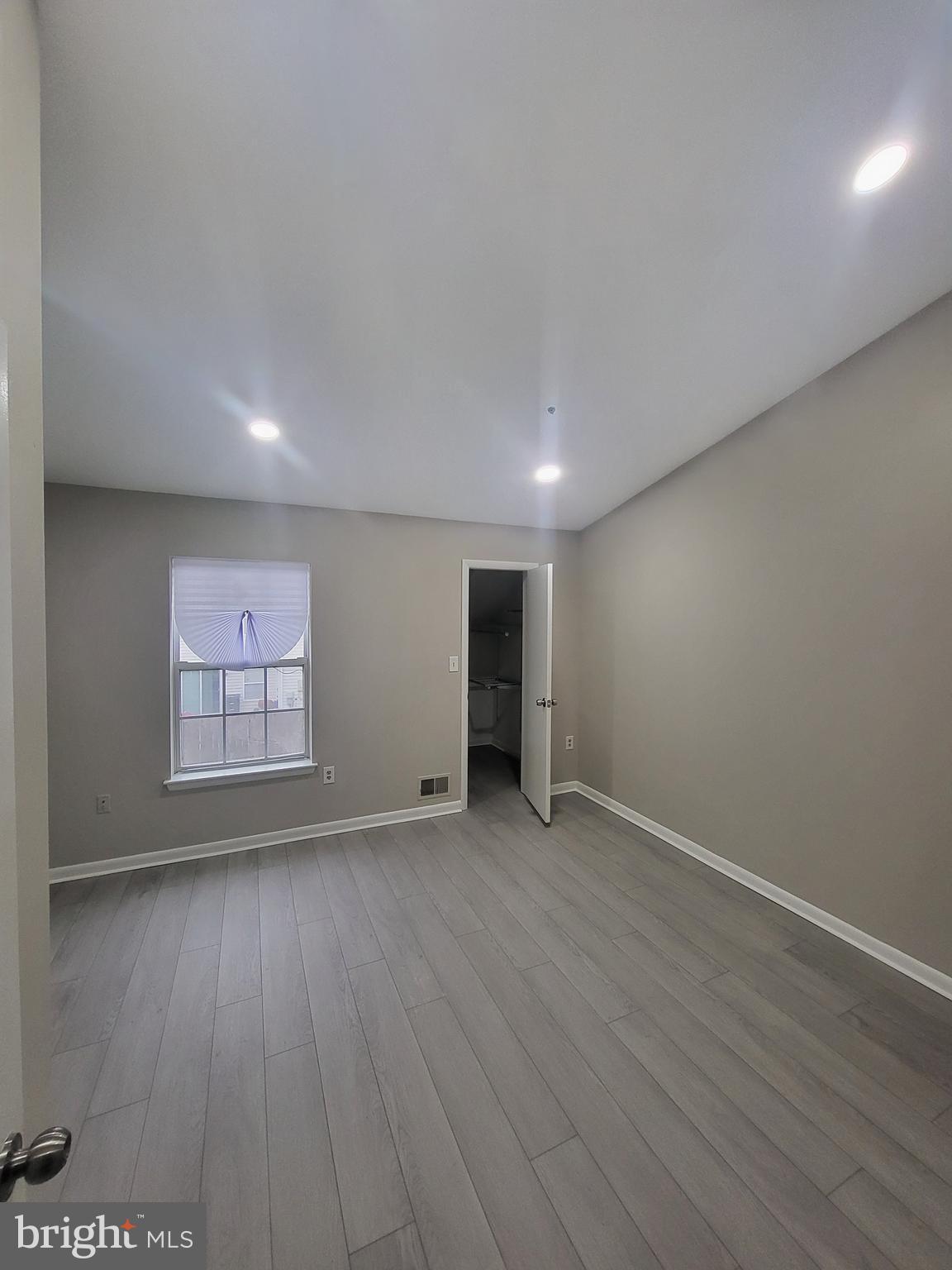3203 Prince Ranier Place District Heights, MD 20747 - Photo 13 of 18 an empty room with wooden floor and windows