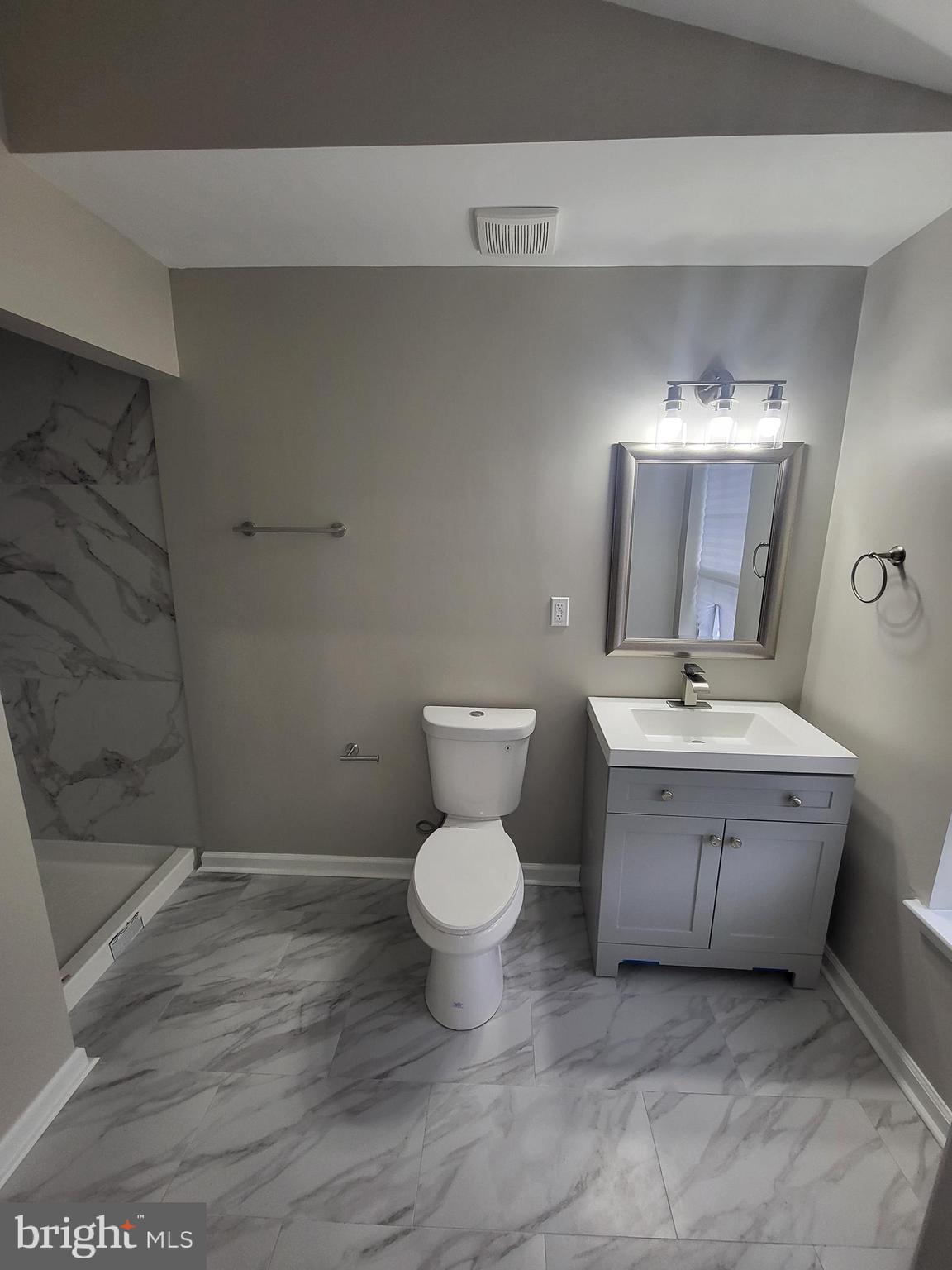 3203 Prince Ranier Place District Heights, MD 20747 - Photo 14 of 18 a bathroom with a toilet sink and mirror