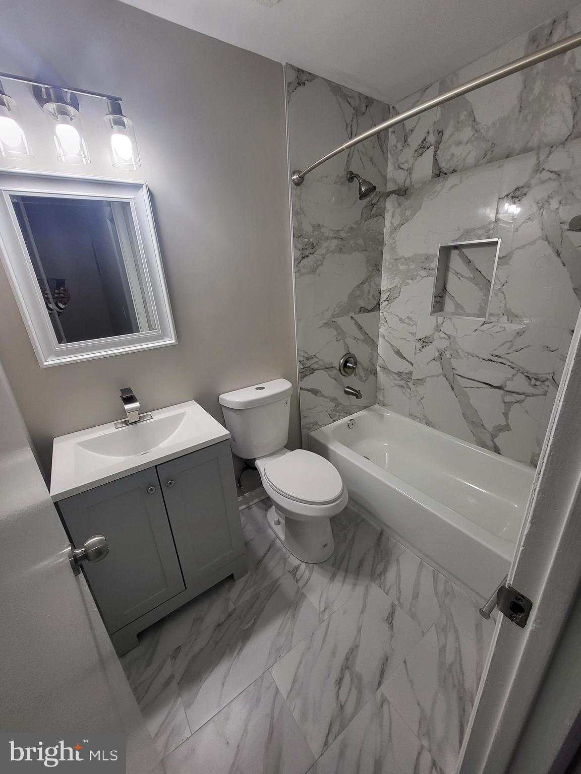 3203 Prince Ranier Place District Heights, MD 20747 - Photo 15 of 18 a bathroom with a sink mirror vanity and toilet