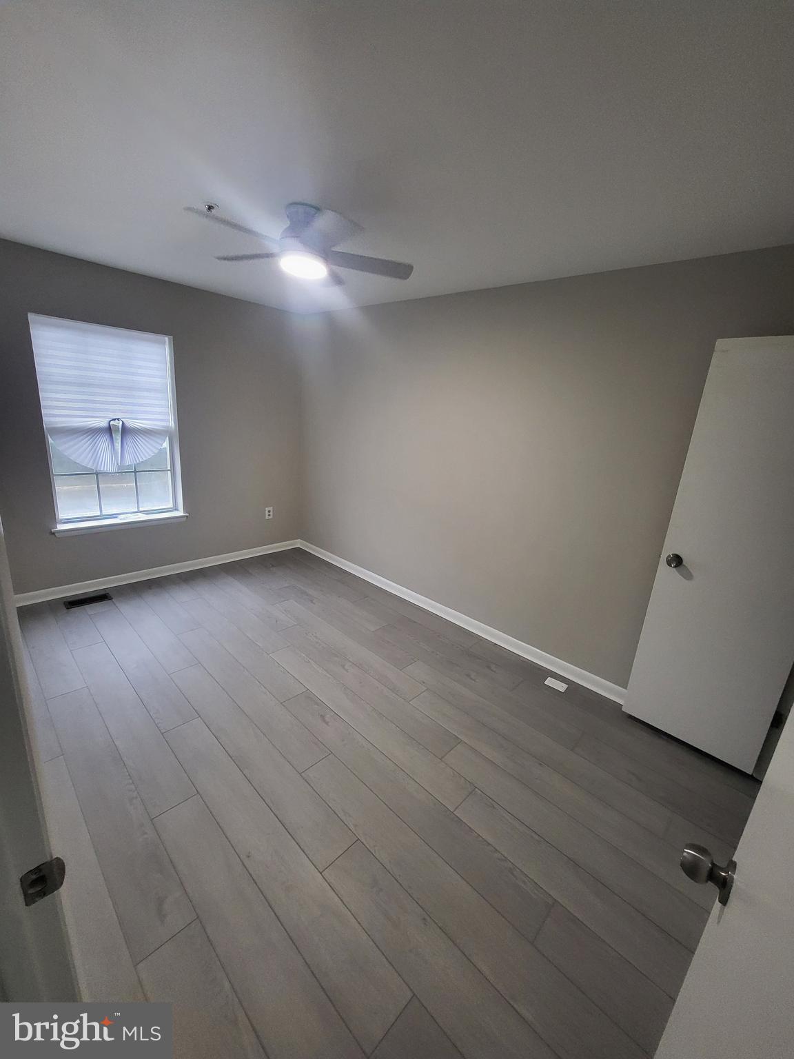 3203 Prince Ranier Place District Heights, MD 20747 - Photo 16 of 18 an empty room with wooden floor and windows