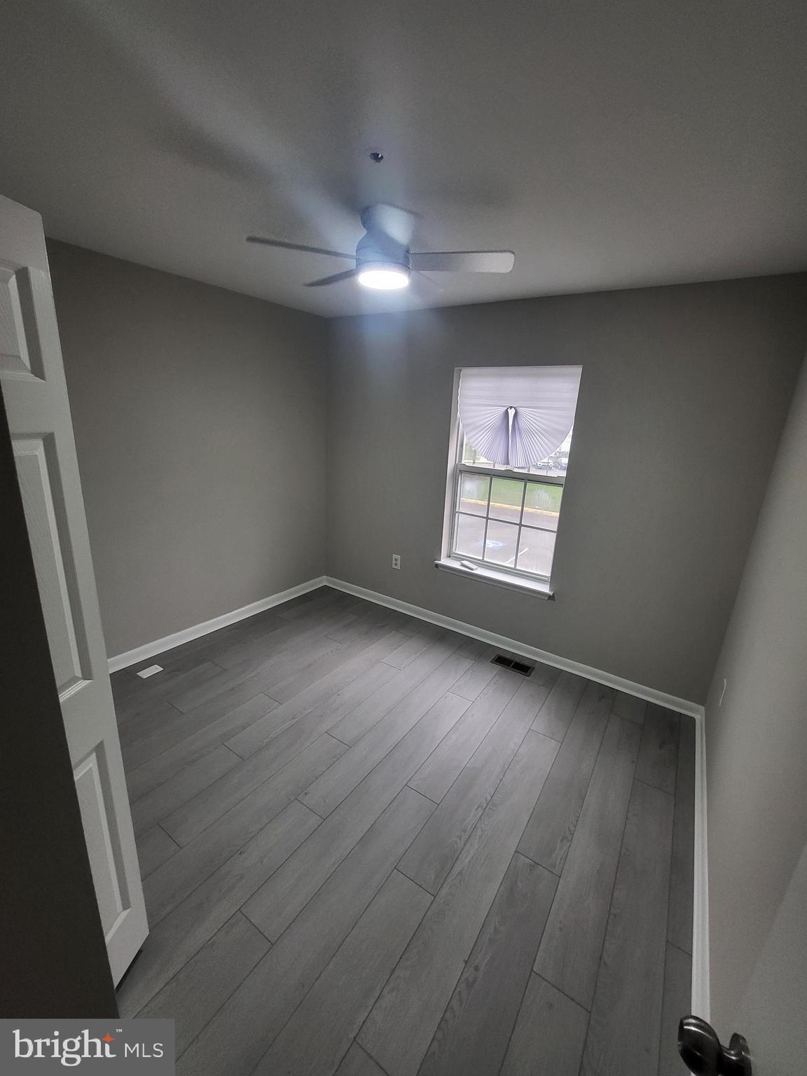 3203 Prince Ranier Place District Heights, MD 20747 - Photo 17 of 18 an empty room with wooden floor and windows