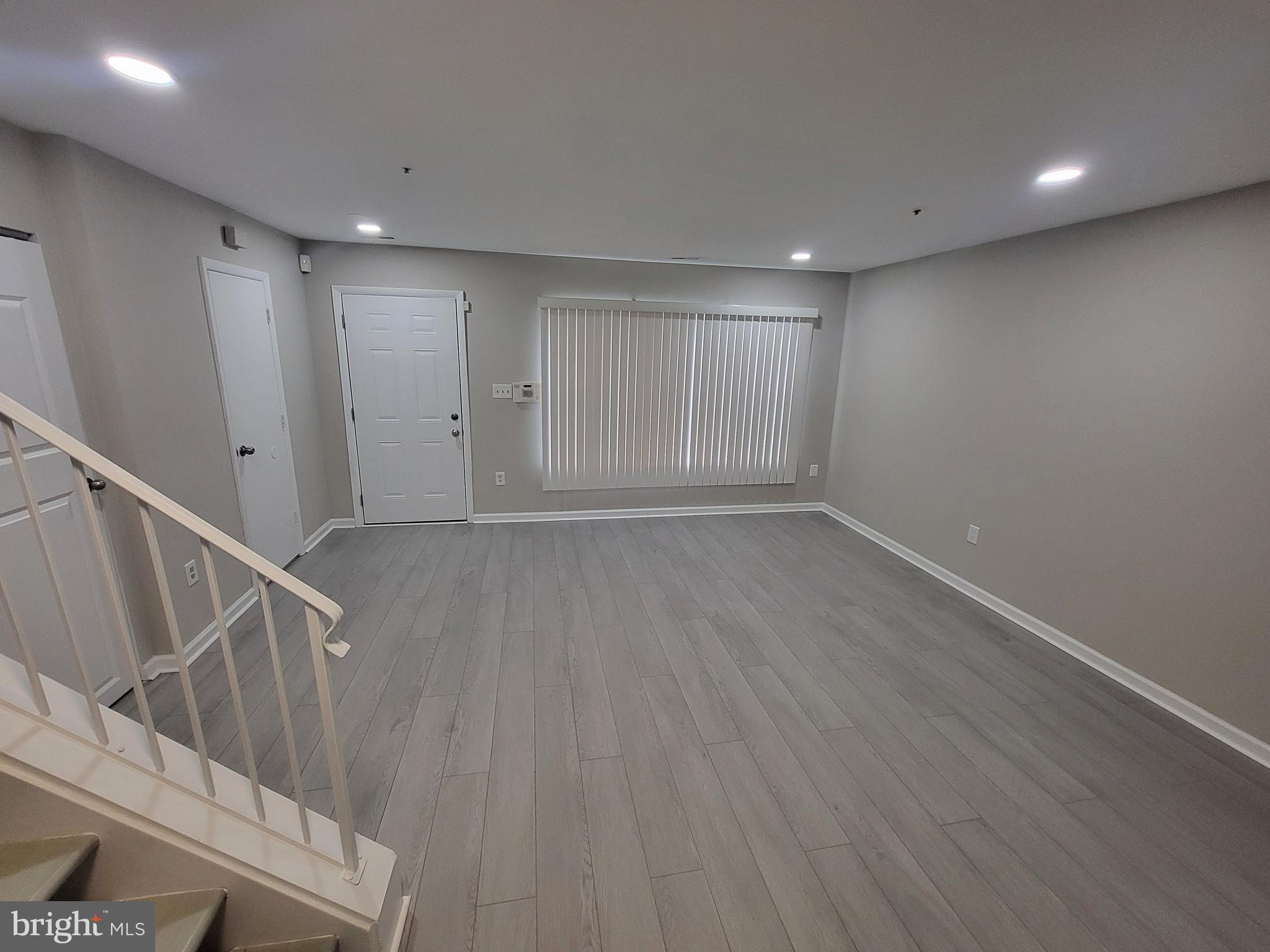 3203 Prince Ranier Place District Heights, MD 20747 - Photo 2 of 18 a view of an empty room with wooden floor and stairs