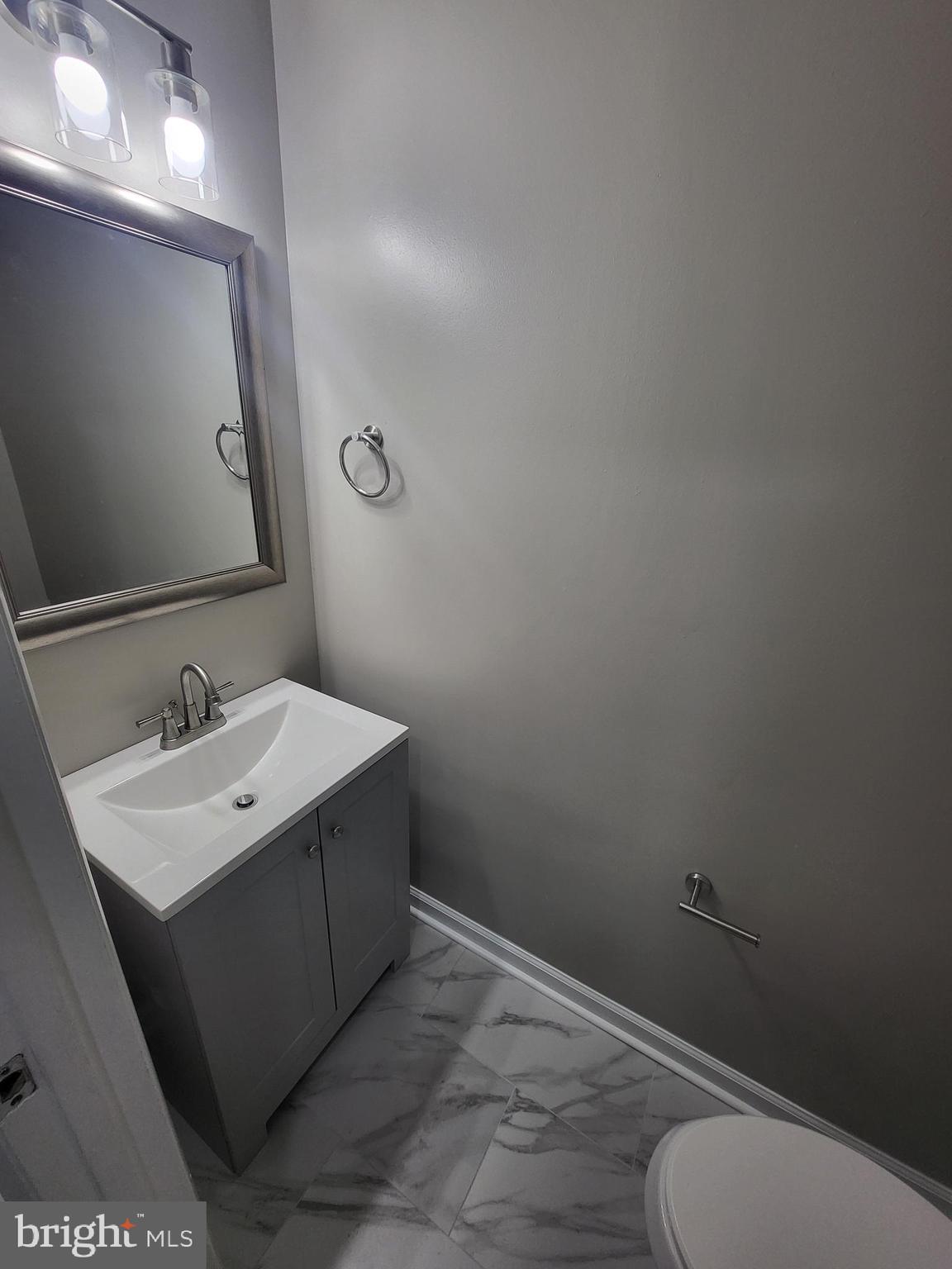 3203 Prince Ranier Place District Heights, MD 20747 - Photo 3 of 18 a bathroom with a sink vanity mirror and toilet