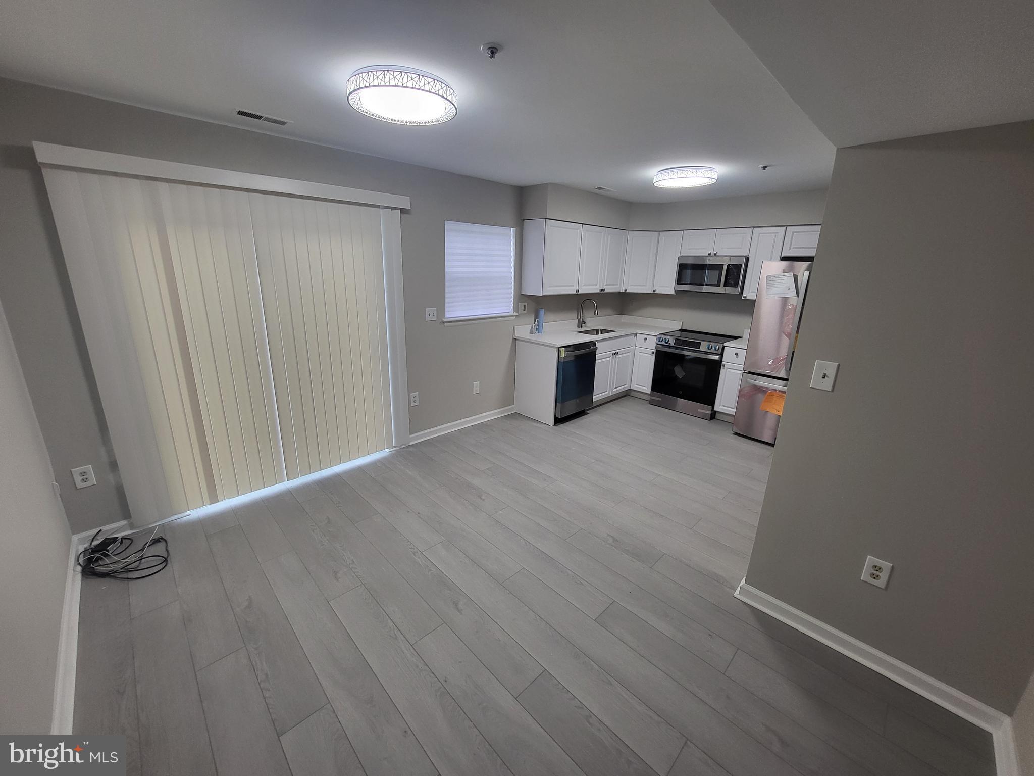 3203 Prince Ranier Place District Heights, MD 20747 - Photo 4 of 18 a view of a kitchen with a sink cabinets and wooden floor