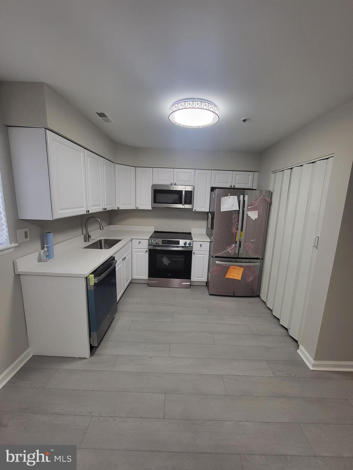 3203 Prince Ranier Place District Heights, MD 20747 - Photo 5 of 18 a kitchen with granite countertop a stove top oven and cabinets