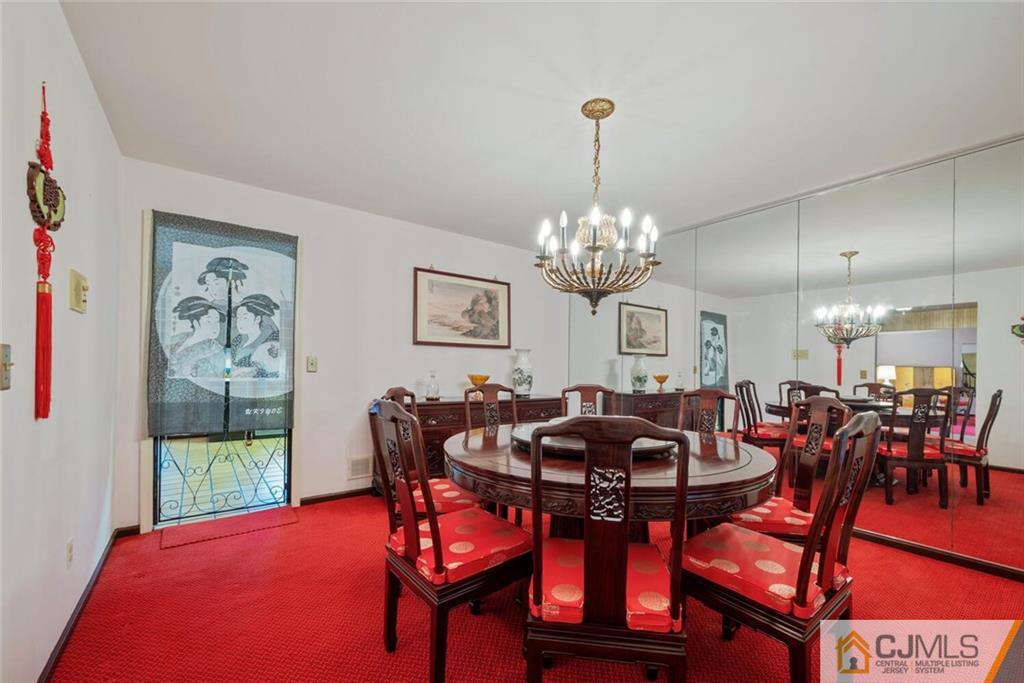 1 Winter Street Edison, NJ 08820 - Photo 10 of 36 a view of a dining room with furniture a chandelier and wooden floor