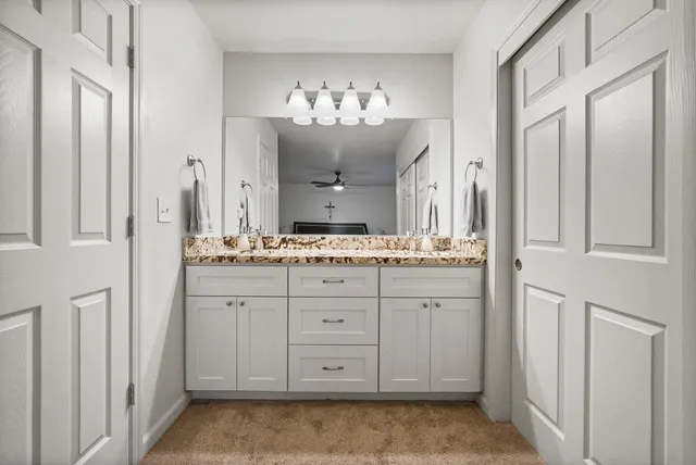 a bathroom with a double vanity sink and mirror