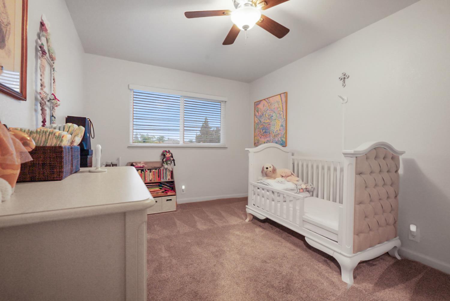 1820 North Berkeley Avenue Turlock, CA 95382 - Photo 19 of 29 a bed room with a bed and a chandelier