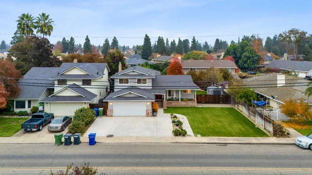 an aerial view of a house with yard swimming pool and outdoor seating