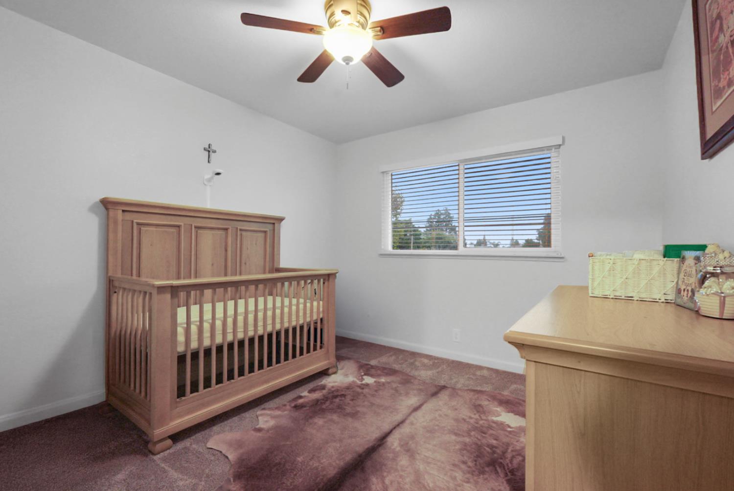 1820 North Berkeley Avenue Turlock, CA 95382 - Photo 21 of 29 a bedroom with a bed and a window