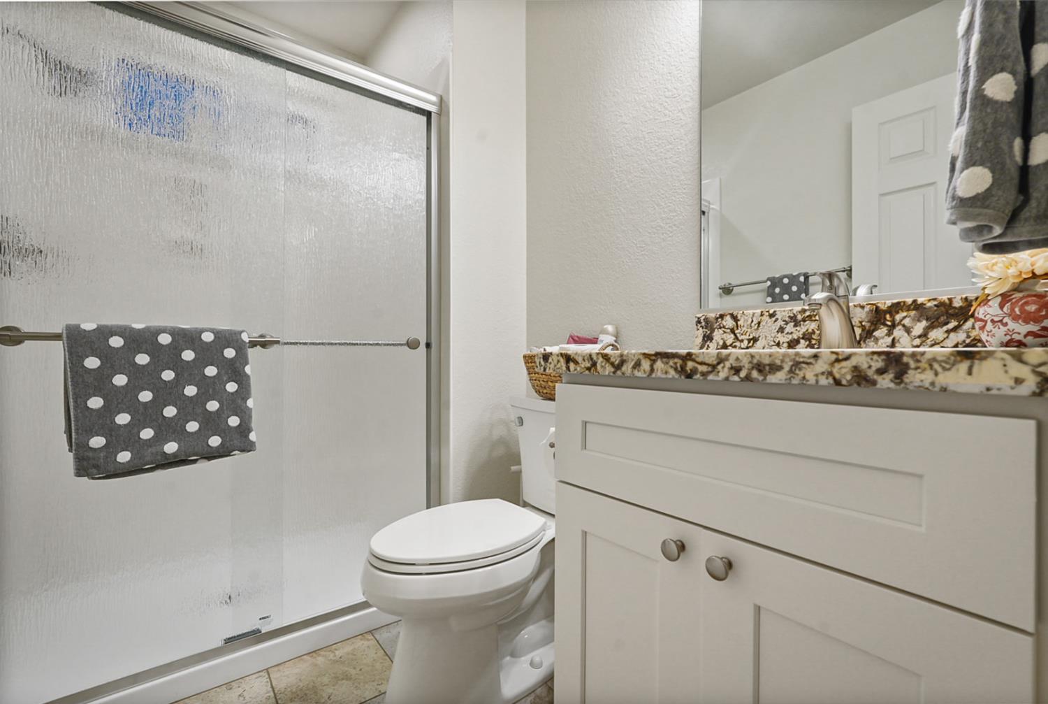 1820 North Berkeley Avenue Turlock, CA 95382 - Photo 22 of 29 a bathroom with a toilet sink and vanity